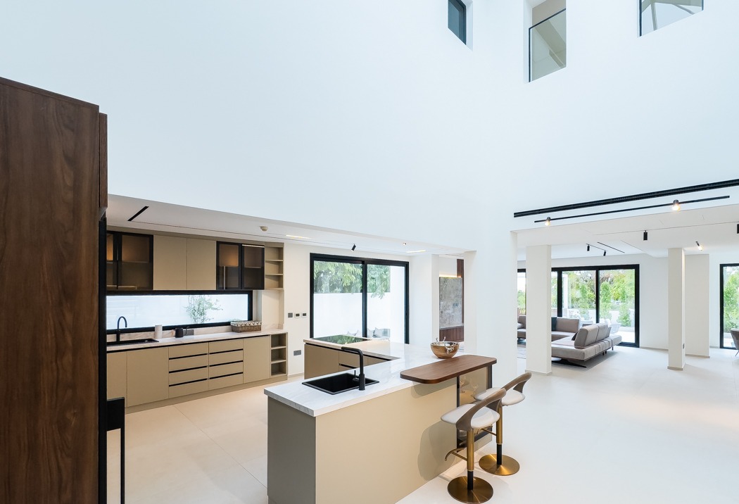 Double-height open-plan kitchen and living space at the Lime Tree Valley villa