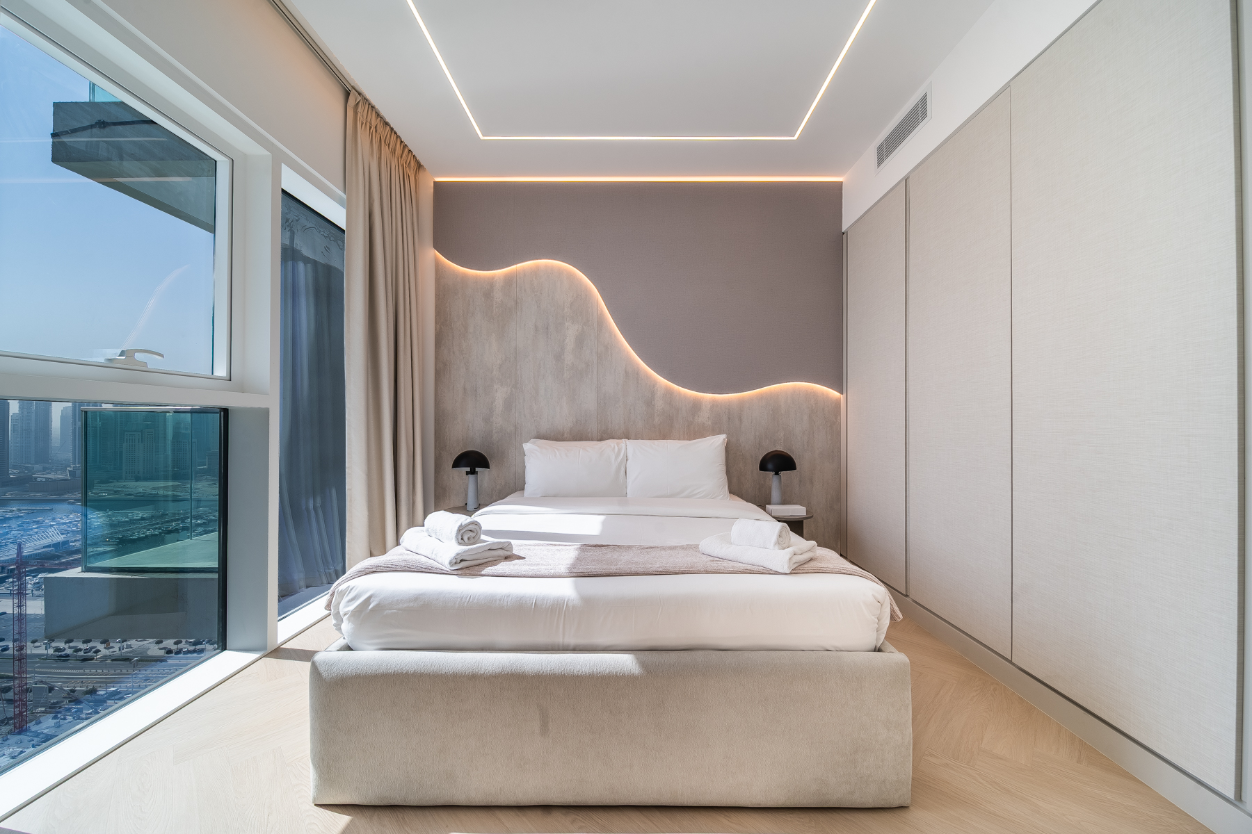 Second bedroom with curved illuminated headboard wall at Emaar Beachfront