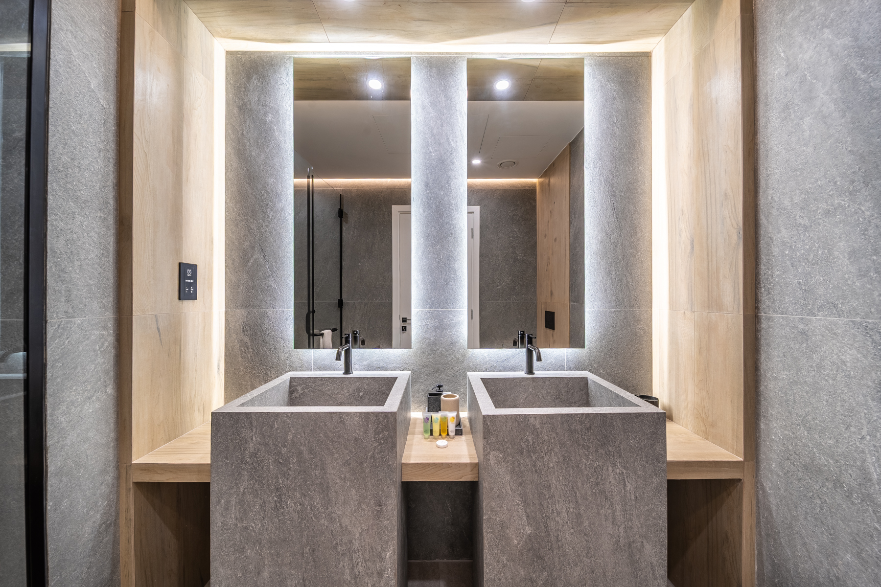 Twin stone vanities with backlit mirrors at Emaar Beachfront