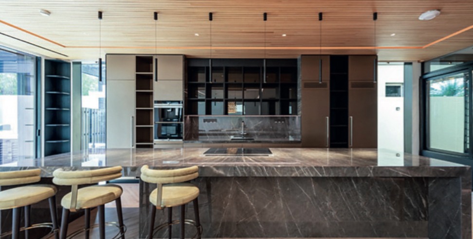 Renovated kitchen with stone island at a Sanctuary Falls villa, Jumeirah Golf Estates