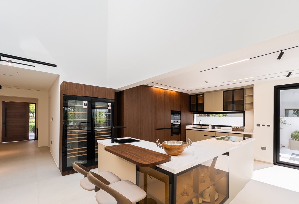Kitchen with marble island and walnut joinery at the Lime Tree Valley villa