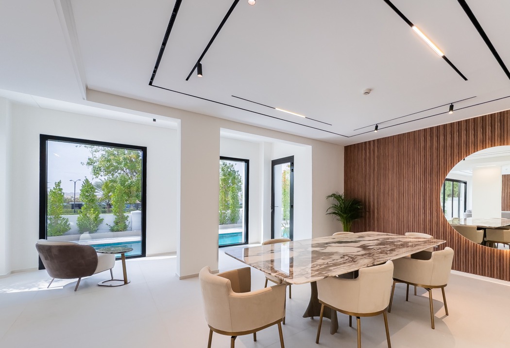 Dining room with marble table and fluted timber wall at the Lime Tree Valley villa